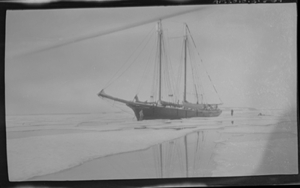 Image of Vessel moored (GODTHAAB?). Men on ice floe nearby